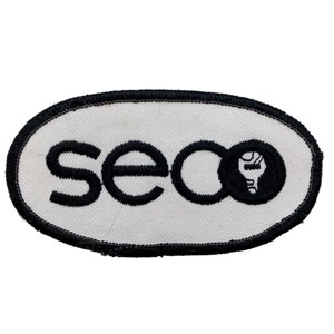 May include: White oval patch with black embroidered text "seoo" and a black circle with a stylized lightbulb inside.