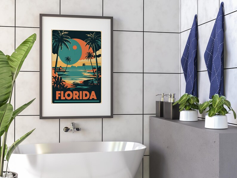 Peut inclure: Une affiche encadr&eacute;e avec un design r&eacute;tro repr&eacute;sentant une sc&egrave;ne de plage avec des palmiers et un grand cercle bleu et orange. Le texte "FLORIDA" est imprim&eacute; en orange en bas de l'affiche.
