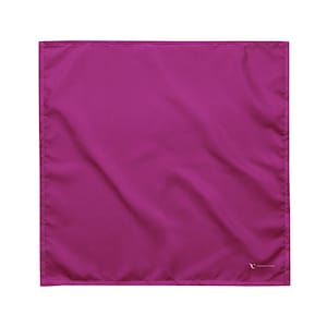 May include: A square magenta bandana featuring a smooth, solid-coloured fabric texture with stitched edges. A small, white logo is printed in the bottom right corner, displaying the text "TRONAR CAKU" in a clean, sans-serif font style.