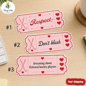 May include: Three pink ticket-shaped stickers with red accents. Each sticker features a hockey stick design and a different phrase: "Respect", "Don't blush", and "dreaming about fictional hockey players". Red hearts are also included.