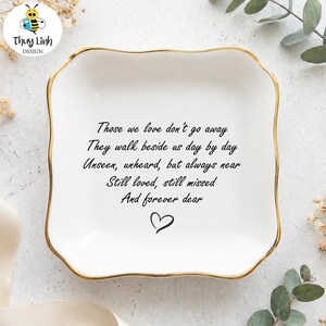 May include: A white ceramic dish with a gold rim, featuring a heartfelt poem and a heart symbol. The text reads "Those we love don't go away..." This decorative dish is a thoughtful keepsake.