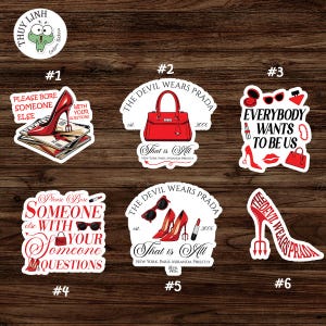 May include: A selection of fashion-themed stickers with red high heels, handbags, and text. The stickers include phrases like "The Devil Wears Prada" and "Everybody Wants to Be Us."
