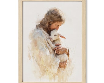 May include: Watercolor print in a light wood frame. The artwork depicts a figure in white robes tenderly holding a lamb. The color palette is soft, with warm tones and a focus on the figures' embrace. The background is a soft, neutral color.