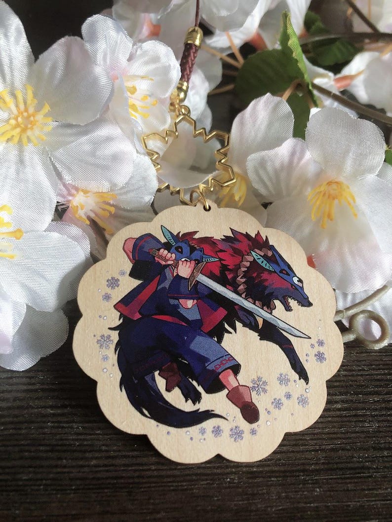 May include: A wooden charm featuring a character with a sword and a wolf. The charm is decorated with snowflakes and has a gold snowflake charm attached to it.