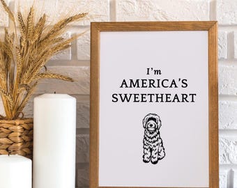 May include: A framed print with a black and white illustration of a dog and the text "I'm America's Sweetheart".