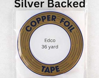 May include: A roll of gold-colored copper foil tape with the text "Copper Foil Tape" printed in black around the outside of the roll. The text "Edco 36 yard" is printed in black on a white background inside the roll. The roll is packaged in a clear plastic bag with the text "Silver Backed" printed in black at the top.