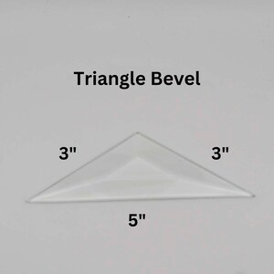 May include: Triangle Bevel with measurements: 3 inches by 3 inches by 5 inches.