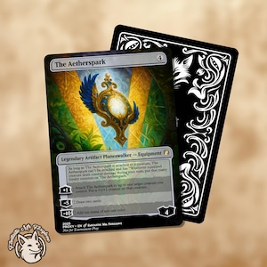 Może przedstawiać: Karta Magic: The Gathering zatytułowana "The Aetherspark" ze szczegółową ilustracją złotego i niebieskiego artefaktu. Karta ma czarną obwódkę i białe tło z tekstem. Druga karta z dekoracyjnym czarnym wzorem jest z tyłu.