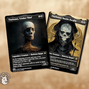 May include: Two fantasy trading cards featuring skeletal figures. One card is titled "Tinybones, Trinket Thief" and the other "Tinybones, Bauble Burglar." The cards have dark backgrounds with detailed illustrations of the skeleton characters. The cards are labeled as "Legendary Creature - Skeleton Rogue."