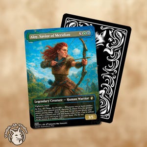 Op de afbeelding: Aloy, Savior of Meridian kaart met een vrouw met rood haar die een pijl en boog richt. De kaart heeft een blauwe en groene achtergrond met de tekst "Legendary Creature - Human Warrior". Een zwarte kaart met een wit ontwerp erachter.