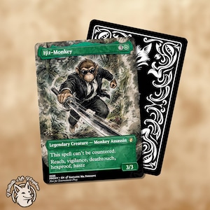 May include: A trading card featuring an illustration of a monkey in a black suit and sunglasses holding a sword, with the text Hit-Monkey, Legendary Creature - Monkey Assassin, and game rules. A second card with a black and white floral design.