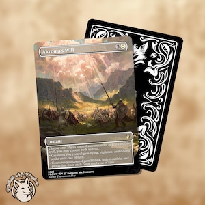 May include: A fantasy card featuring the text "Akroma's Will" with a battlefield scene illustration. The card has a black backing with a white decorative design. The card also includes the text "Instant" and game instructions.