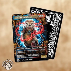 May include: A Magic: The Gathering card featuring "Lutri, the Spellchaser," an Elemental Otter. The card has a brown otter illustration with blue and red energy effects. A black card with white decorative swirls is behind it. The card reads "3/2."