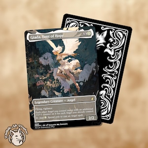 May include: A collectible card featuring an angel with white wings and a flowing dress, titled "Giada, Font of Hope." The card has a black border and a detailed illustration. The card also has the text "Legendary Creature - Angel" and "2/2".