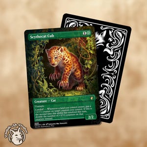 May include: A green and black trading card featuring a Scythecat Cub, a creature cat with orange and brown spots. The card has text including "Trample" and "Landfall". A black card with white decorative elements is behind it.