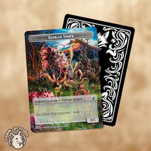 Peut inclure: Une carte Magic: The Gathering représentant une créature Eldrazi Spawn. La carte est une créature jeton avec une force de 0 et une endurance de 1. La carte a un fond blanc avec une bordure bleue. La créature est un monstre Eldrazi multi-oculaire, tentaculaire, avec une gueule béante. Le texte de la carte indique "Créature jeton - Eldrazi Spawn" et "Sacrifiez cette créature : Ajoutez o."