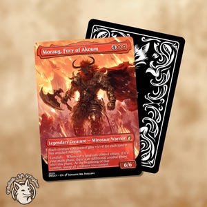 May include: A Magic: The Gathering card featuring the Minotaur Warrior, Moraug, Fury of Akoum, with a fiery background. The card is red with black text and a 6/6 power/toughness. A black card with white decorative swirls is behind it.