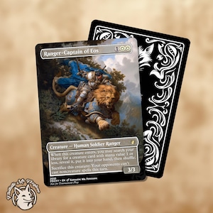 May include: A Magic: The Gathering card featuring a knight riding a lion, titled "Ranger-Captain of Eos." The card has a detailed illustration with text describing the creature's abilities. A black card with white ornate designs is behind it.