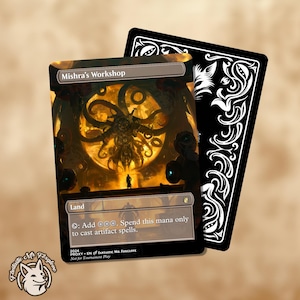 May include: A Magic: The Gathering proxy card featuring "Mishra's Workshop" with a dark, detailed illustration. The card has a black border and text that reads "Land" and spell instructions. A black card back is visible.