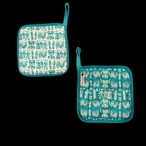 May include: Two square pot holders with a teal border and hanging loop. The pot holders have a white background with a teal pattern of roosters, people, and wheat. One pot holder has a tag that says "RUSTIC TIMBER".