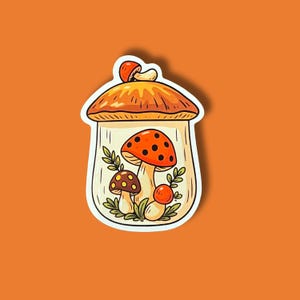 May include: A whimsical sticker featuring a mushroom scene inside a glass jar. The mushrooms are in shades of orange, brown, and white, with green foliage. The jar has a brown cap with a small mushroom on top. The sticker is on an orange background.