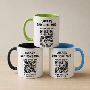 May include: Three white ceramic mugs with colored interiors and handles in lime green, black, and light blue. Each mug features the text "LUCAS'S DAD JOKE MUG", "JOKE OF THE DAY", a QR code, and "SCAN DAILY FOR EYE ROLLS" printed in black ink.