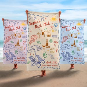 May include: Three beach towels with a beach-themed design are held up on a sandy beach. Each towel has the text "Hayden's Bach Club" and "April, 2026 Orange Beach Alabama". The towels are in light pink, cream, and light blue.
