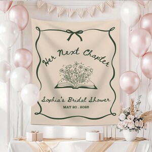 May include: A beige tapestry with dark green accents, featuring the text "Her Next Chapter" and "Sophia's Bridal Shower" with the date May 20, 2026. The design includes an open book with floral illustrations. Balloons and decorations surround the tapestry.