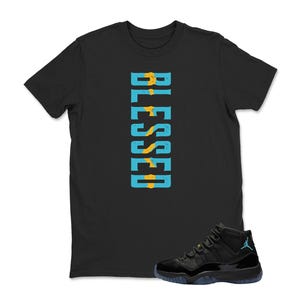 May include: Black t-shirt with the word "BLESSED" in vertical turquoise and yellow letters. A pair of black and turquoise sneakers is at the bottom right of the image.