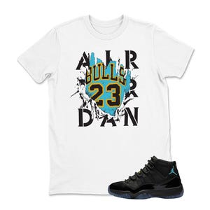 May include: White t-shirt with a graphic featuring "Bulls 23" in black and gold, with a turquoise background. The text "AIR JORDAN" is also visible. A pair of black and turquoise sneakers is in the foreground.