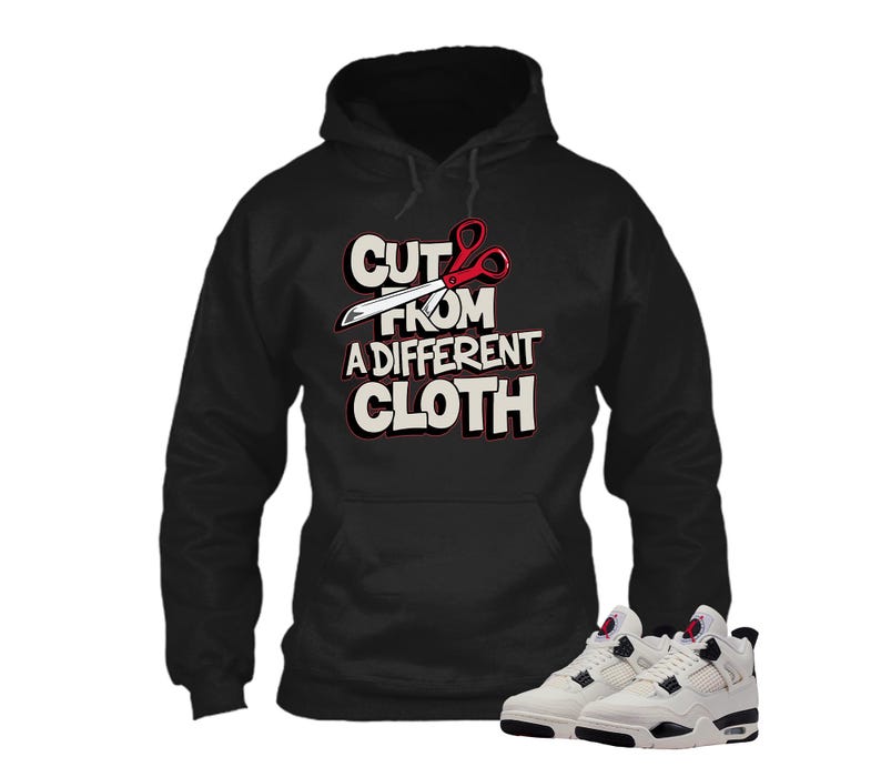 May include: Black hoodie with the text "CUT FROM A DIFFERENT CLOTH" in white and red. The hoodie has a front pocket and a drawstring hood. A pair of white and black sneakers are at the bottom of the image.