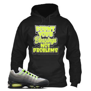 May include: A white ceramic mug with a black handle and the text "But First, Coffee" in a black, handwritten-style font. The mug is on a white surface.