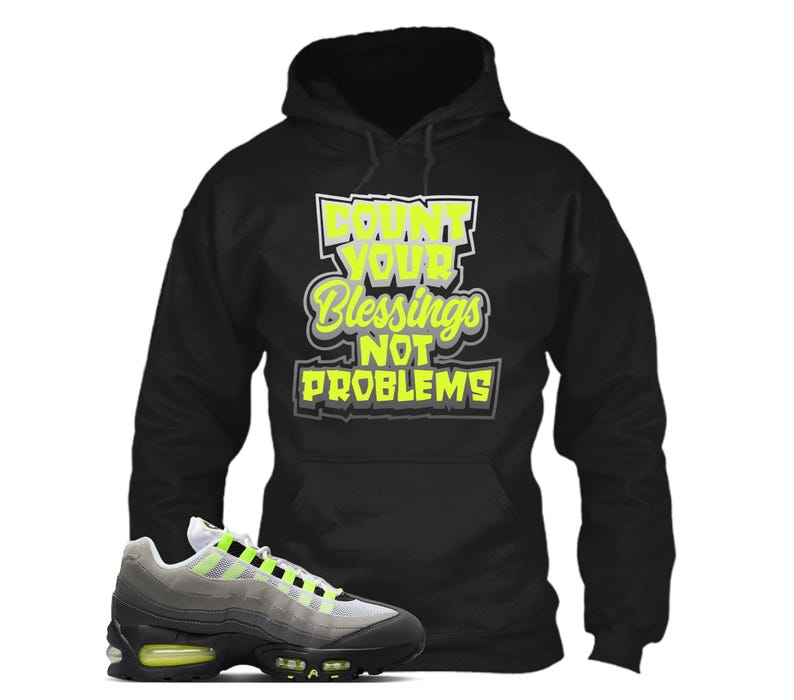 May include: A white ceramic mug with a black handle and the text "But First, Coffee" in a black, handwritten-style font. The mug is on a white surface.