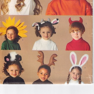 May include: A vintage sewing pattern for children's Halloween costumes. The pattern includes eight different costumes: a pumpkin, a sunflower, a cow, a devil, a reindeer, a bunny, a skunk, and a star. The pattern is from Butterick and is size one.