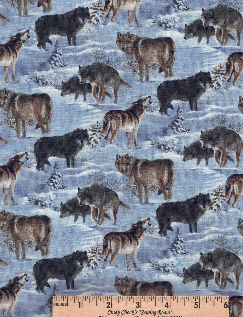 May include: Textile with a repeating pattern of wolves in a snowy scene. The wolves are in shades of brown, black, and grey, some howling. Small evergreen trees are scattered across a light blue background, creating a wintery theme.