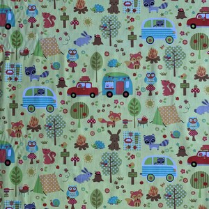 May include: A light green fabric with a repeating pattern of camping scenes. The design includes red cars, blue and green campers, woodland animals, campfires, trees, and tents. The fabric has a playful, outdoorsy theme.