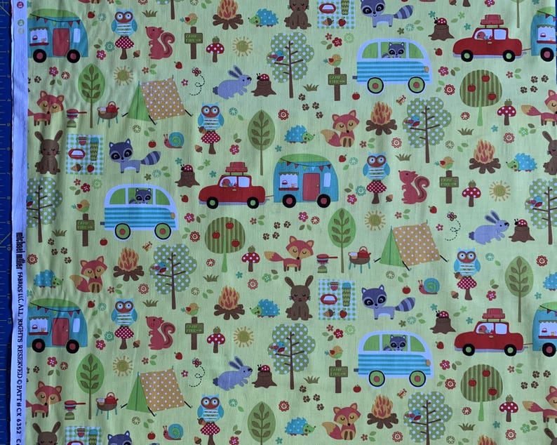 May include: A light green fabric with a repeating pattern of camping scenes. The design includes red cars, blue and green campers, woodland animals, campfires, trees, and tents. The fabric has a playful, outdoorsy theme.