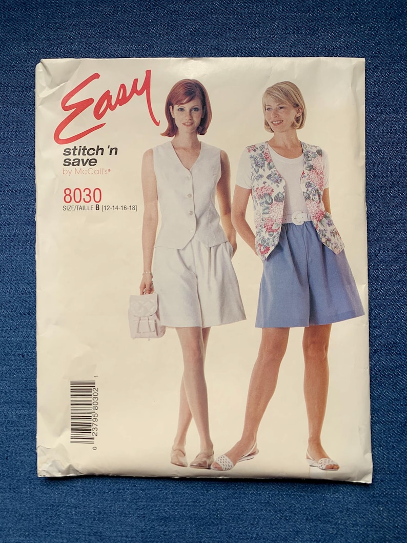 May include: A vintage sewing pattern labelled "Easy stitch 'n save by McCall's 8030." The pattern shows two women modelling outfits. One wears a white vest and shorts, the other a floral vest and blue skirt. The size is B [12-14-16-18].