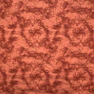May include: A piece of fabric featuring a mottled, marbled pattern in shades of burnt orange and deep reddish-brown. The surface has a textured appearance with irregular, swirling dark lines distributed across the lighter orange base.