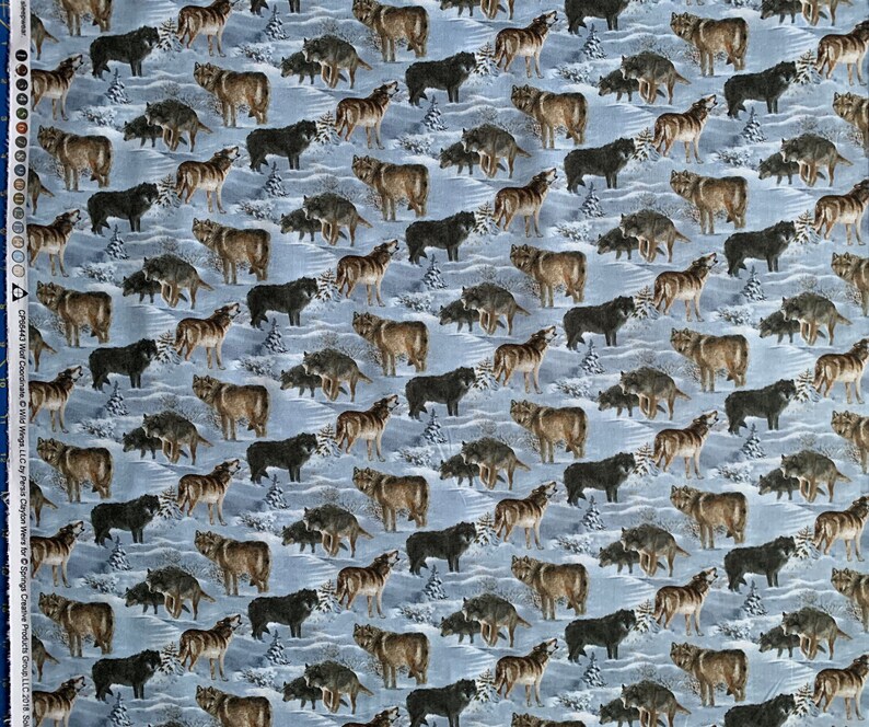 May include: A patterned fabric featuring numerous wolves in shades of brown and black, set against a light blue snowy backdrop. Some wolves are depicted howling. Small evergreen trees are also included in the design.