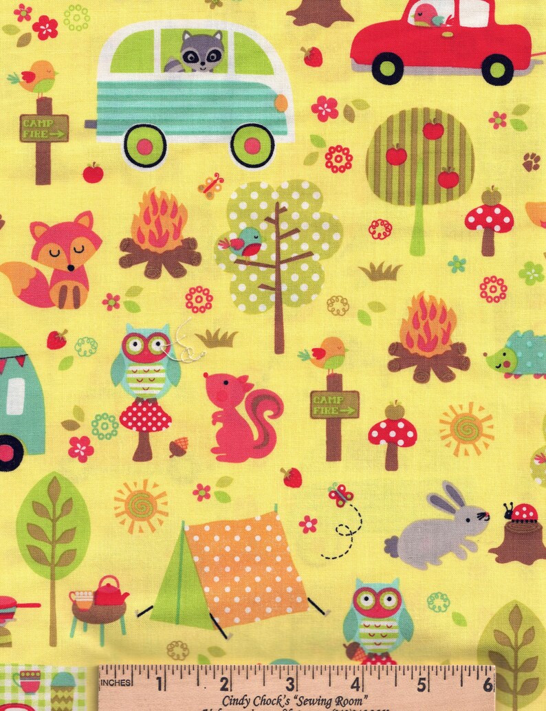 May include: Yellow fabric with a camping theme. Features a raccoon in a camper, a red car, a fox, an owl, a squirrel, a tent, and a campfire. Includes the text "CAMP FIRE". The fabric has a repeating pattern of trees, flowers, and animals.