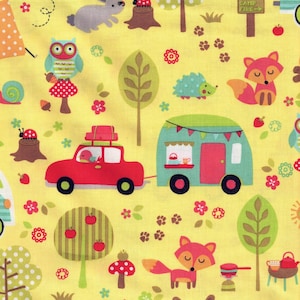 May include: Yellow fabric with a whimsical woodland scene. Features a red car pulling a teal camper, along with foxes, owls, rabbits, and trees. The design includes mushrooms, flowers, and the text "CAMP FIRE". Measurements are in inches.
