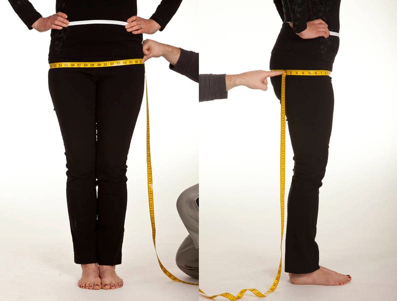 May include: A person wearing black pants and a black top is having their hip measurement taken with a yellow measuring tape. The person is standing in front of a white background. The image shows both a front and side view of the person.