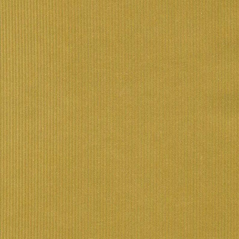 May include: A close-up of a textured fabric with a corduroy weave. The fabric is a muted yellow color.