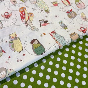 May include: Fabric featuring a whimsical owl pattern on a white background. The owls are in various colors and poses, connected by curved lines. A green fabric with white polka dots is visible below the owl fabric.