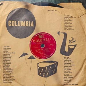 May include: Vintage Columbia Records album cover featuring a red and white record with the song title "The First Time I Kissed You." The cover is tan with black graphics and artist names, including Kay Kyser.