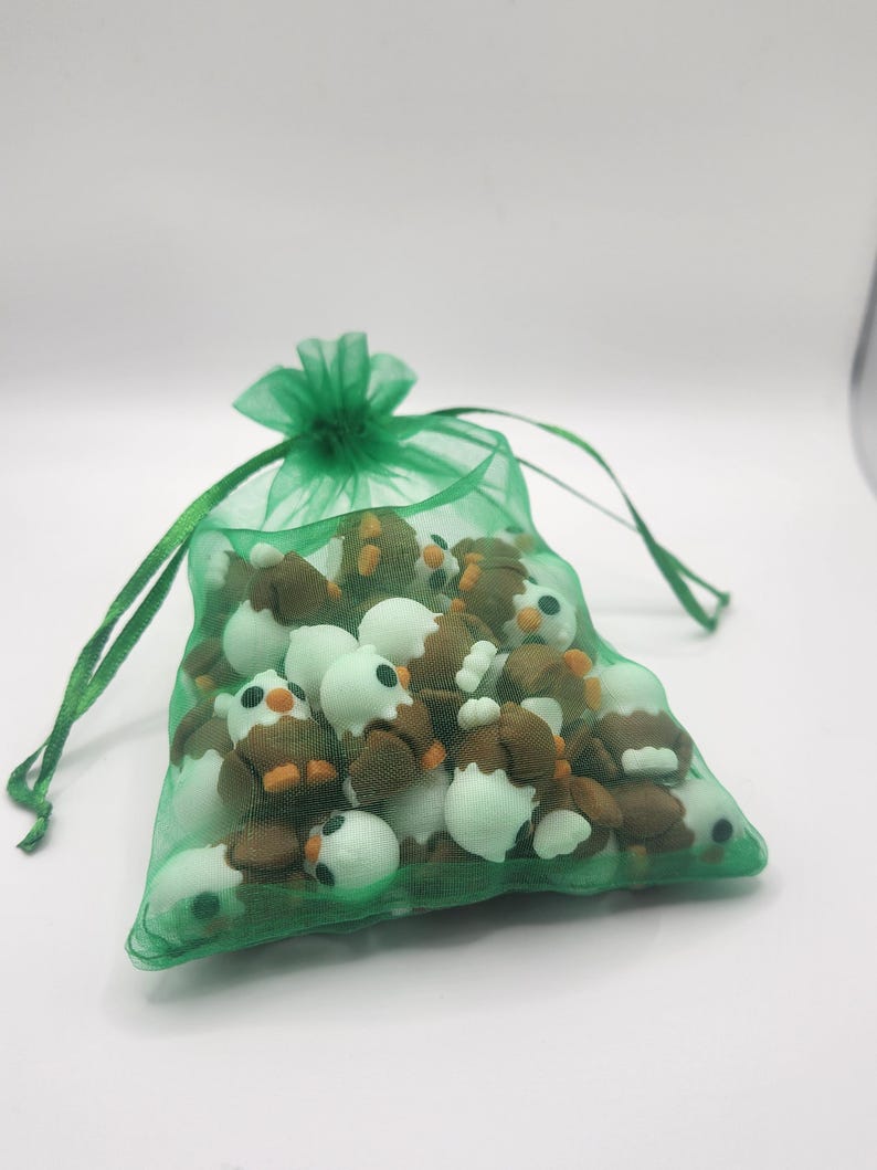 May include: A green mesh bag filled with small brown and white owl figurines.