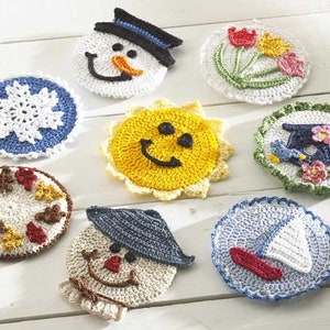 May include: Set of 8 crocheted coasters featuring various seasonal designs, including a snowman, a snowflake, a sun, a flower, a bird, a sailboat, a scarecrow, and a fall leaf design.