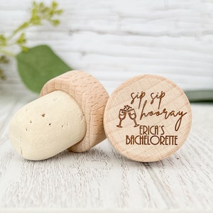 Personalized wine bottle stopper made from 100 percent real cork with an engraved wooden top with the words sip sip hooray, two wine glasses and the brides bachelorette info. Perfect for wedding favors, bachelorette favors and wedding shower gifts.