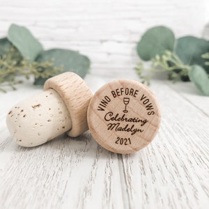 Personalized wine bottle stopper made from 100 percent real cork with an engraved wooden top with the words Vino before vows, a wine glass and the brides bachelorette info. Perfect for wedding favors, bachelorette favors and wedding shower gifts.